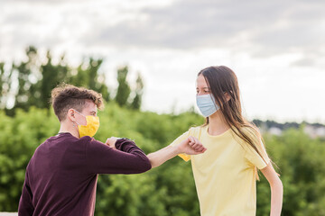 Wall Mural - young friends meeting with social distancing for coronavirus. lifestyle friendship with mask