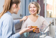 © JackF - Mom and adult daughter talk and drink tea in the kitchen. High quality photo