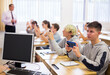 © JackF - Confident teen students using social media on phones while studying in high school