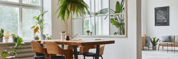 Stylish and botany interior of dining room with design craft wooden table, chairs, furniture, a lof of plants, window, poster map and elegant accessories in modern home decor. Template.