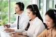 © SEVENNINE_79 - Team of call center staff in Asia wears headphones with a microphone. Smile while serving customers at desks and computers. Service concept and consulting. Communication concept.