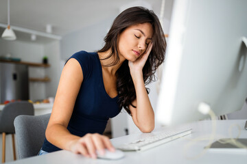 Wall Mural - Young and beautiful businesswoman, student tired from work in home office