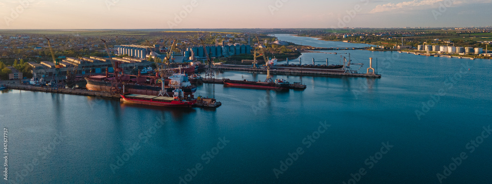 Industrial port in the field of import-export global business logistics and transportation, Loading and unloading container ships, cargo transportation from a bird's eye view. - obrazy, fototapety, plakaty 
