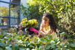 © Wavebreak Media - Smiling mixed race girl planting flowers in backyard