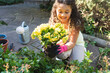 © Wavebreak Media - Smiling mixed race girl planting flowers in backyard
