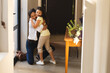 © Wavebreak Media - Happy mixed race mother and daughter hugging in hallway