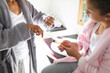 © Wavebreak Media - Midsection of mixed race mother and daughter applying toothpaste on brush in bathroom