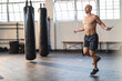© Wavebreak Media - Strong caucasian man exercising at gym, holding rope and skipping