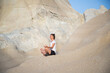 © Melinda Nagy - woman in white doing yoga and meditating by the sea