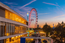 UK, London, Illuminated Royal Festival Hall And London Eye At Sunset