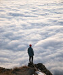 © Travel 'n' Lifestyle - Travel lifestyle view of man on mountain hike above cloud inversion on Roys Peak, near Wanaka, South Island of New Zealand.