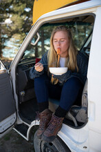 Travel Lifestyle View Of Girl Eating Spaghetti In Vintage Van, Camper Van Life Near Mount Cook, South Island Of New Zealand.