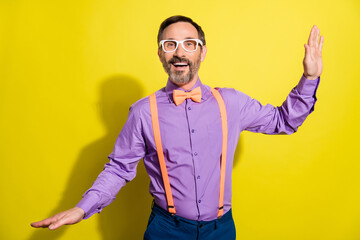 Canvas Print - Photo of handsome mature man happy positive smile have fun wear eyeglasses isolated over yellow color background