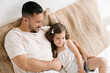 © ADDICTIVE STOCK - Loving father sitting with little daughter on bed at home