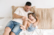 © ADDICTIVE STOCK - Loving father tickling little daughter on bed at home