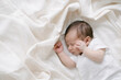 © ADDICTIVE STOCK - Adorable newborn sleeping on bed
