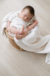 © ADDICTIVE STOCK - Tiny baby sleeping in basket