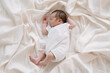 © ADDICTIVE STOCK - Adorable newborn sleeping on bed