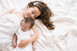 © ADDICTIVE STOCK - Smiling girl lying with newborn on bed