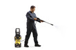© Ljupco Smokovski - Full length profile shot of a worker in a uniform cleaning with a pressure washer machine