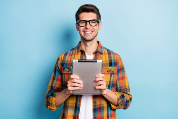 Aufkleber - Portrait of attractive cheerful guy geek holding in hands using device app 5g isolated over bright blue color background