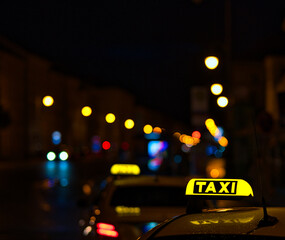 Sticker - Shot of the taxi sign on the car and lights of the street during the nighttime.