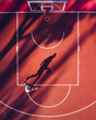 © AmazingAerialAgency - Aerial view of basketball player shadow in outdoor court in Kaunas, Lithuania.