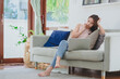 © interstid - Beautiful Asian woman thinking while using laptop notebook for work from home in living room