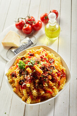 Poster - Portion of tasty fusilli pasta bolognese on the kitchen table; a high angle view