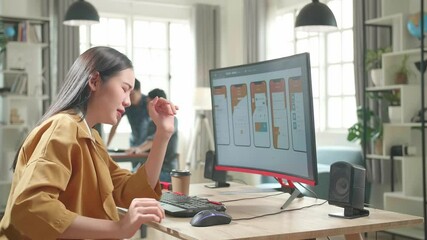 Asian Female Mobile Application Developer Paining Her Back While Works With Graphics On Her Personal Computer In Office
