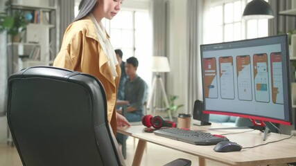 Asian Female Mobile Application Developer Start Works With Graphics On Her Personal Computer In Office
