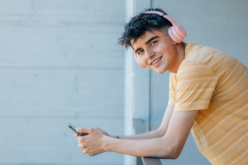 Wall Mural - young man with headphones and mobile phone