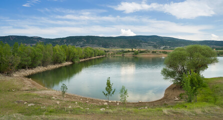 Wall Mural - A beautiful small lake and a cloudy blue sky
