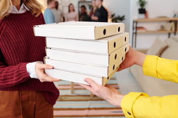 Poster - Young smiling blond female in smart casualwear taking stack of packed pizza