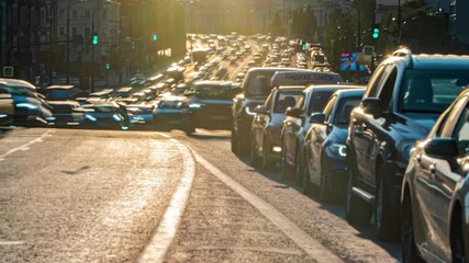 Wall Mural - The movement of cars along a spacious street in the rays of the setting sun, time lapse