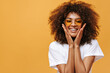 © Look! - Lovely woman in light outfit smiling on yellow background. African girl in bright sunglasses looks into camera on isolated backdrop..