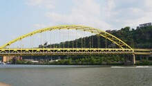 Helicopter On Sky Flying Over Fort Pitt Bridge With Vehicles Driving On Interstate And Fast Jet Skis On Monongahela River In Pittsburgh, Pennsylvania. Air, Ground And Water Transportation Concepts