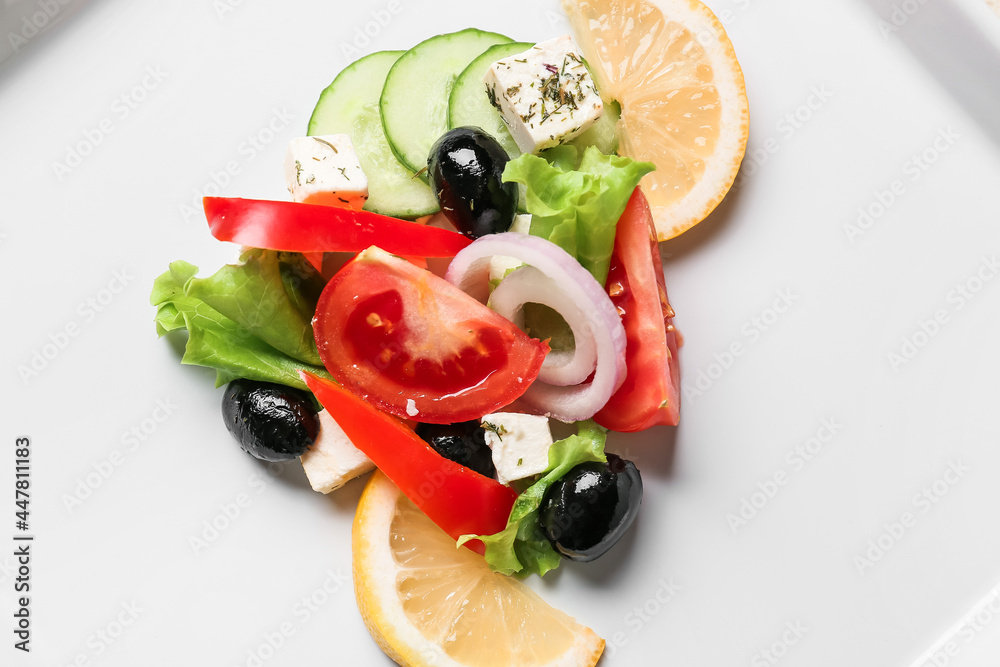 Tasty Greek salad on plate, closeup