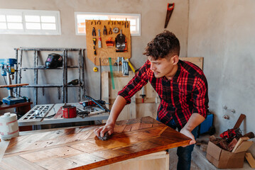 young carpenter waxing wooden box