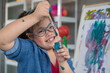 © Bangkok Click Studio - Happy girl with Down syndrome painting on easel