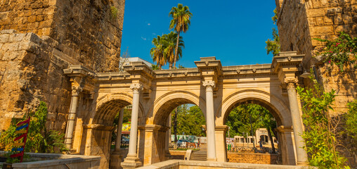 Wall Mural - ANTALYA, TURKEY: Adrian Gate in the background blue sky. Antique ancient construction of marble and limestone.