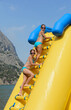 Two tween caucasian girls climbing on yellow inflatable water slide