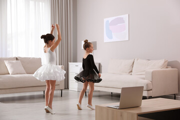 Wall Mural - Cute little girls taking online dance class at home