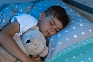 Wall Mural - Cute little boy sleeping with teddy bear at home. Bedtime