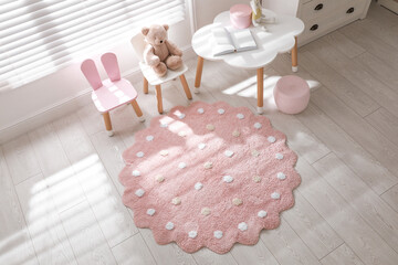 Poster - Round pink rug on floor in children's room, above view