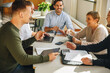 © Jacob Lund - Executives in a meeting discussing on creative ideas