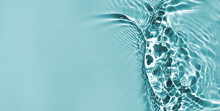 Defocused Blue Liquid Colored Clear Water Surface Texture With Splashes Bubbles With Copy Space. Water Waves In Sunlight Background. Trendy Summer Nature Banner.	