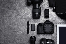 Professional Photography Equipment And Backpack On Grey Stone Table, Flat Lay. Space For Text