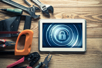 Web security and technology concept with tablet pc on wooden table