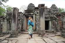 Happy Woman Traveller Walking In Angkor Wat Cambodia.